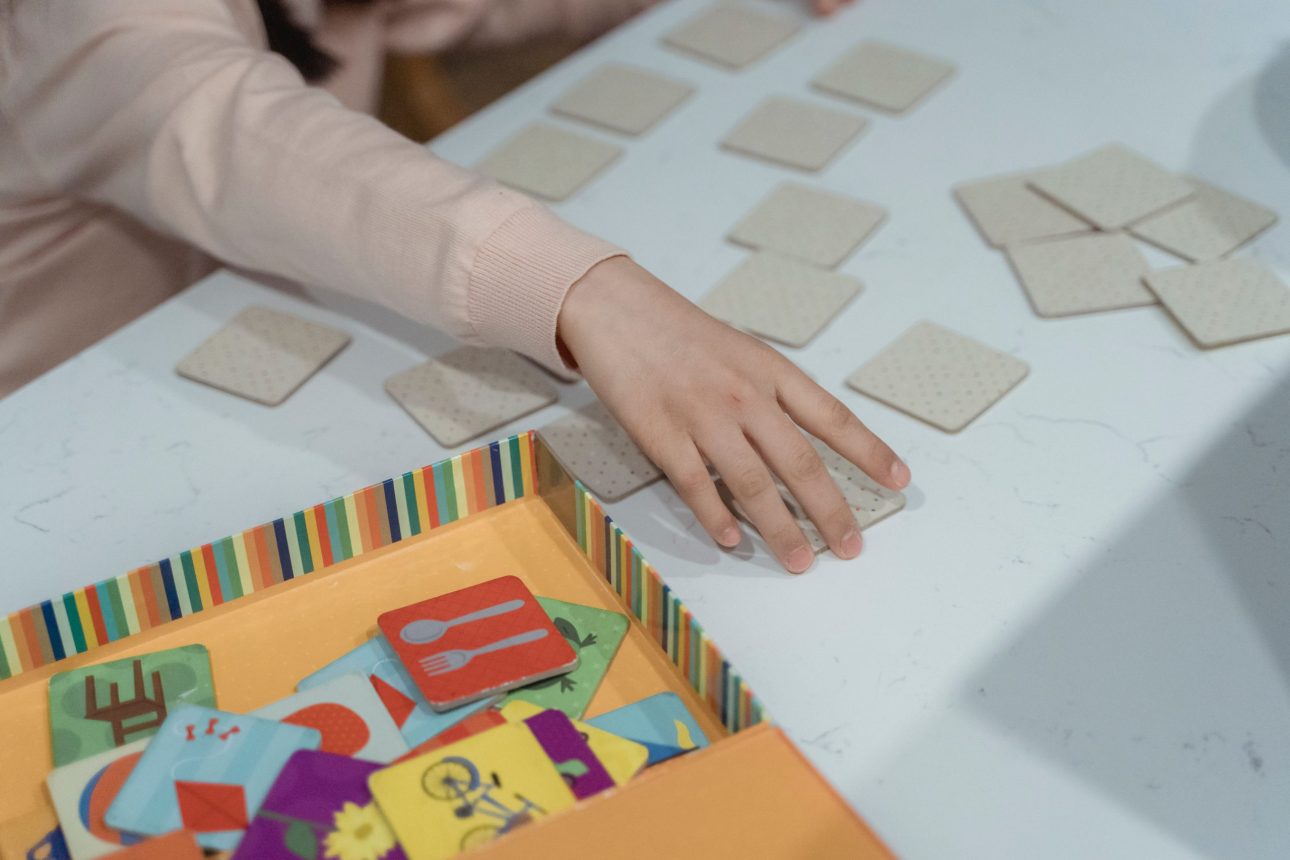Child playing a matching game as part of summer activities for ABA therapy at home