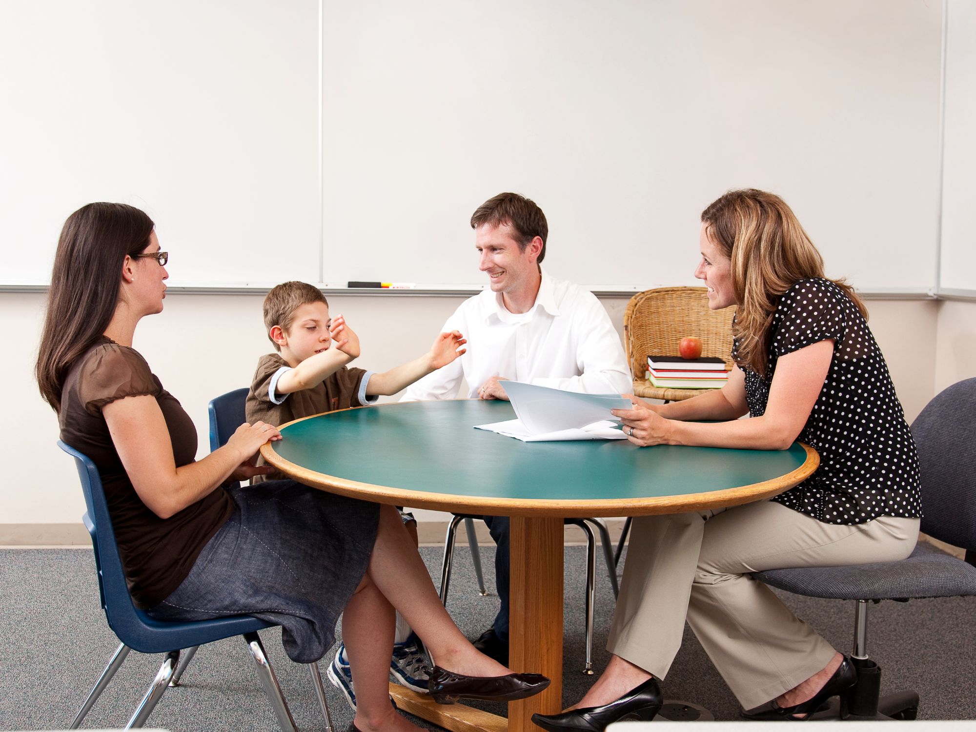 Photo for 82826 Blog Parents and child meeting with a professional to discuss ABA therapy and school support