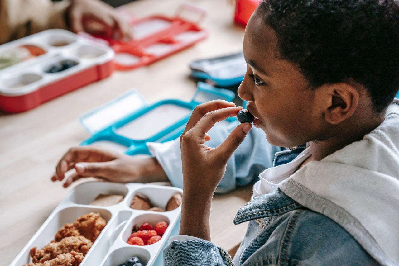 Navigating Autism Sensory Challenges During School Lunch Child with autism receiving support for sensory challenges during school lunch